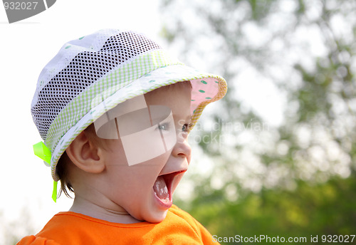 Image of laughing baby in hat outdoor