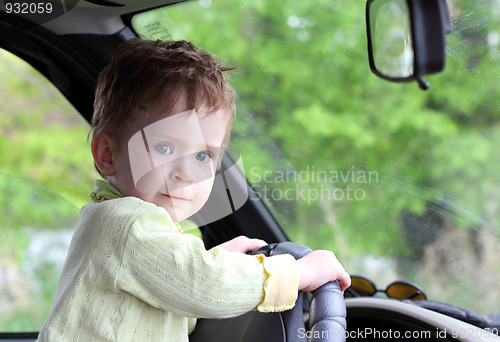 Image of baby holding steering wheel