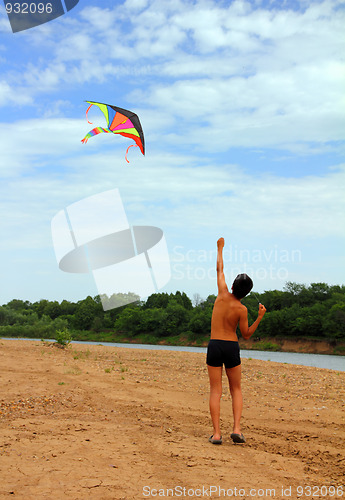 Image of boy running kite