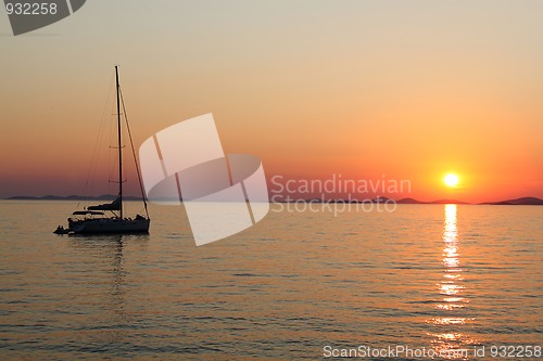 Image of Romantic sunset with silhouette of yacht