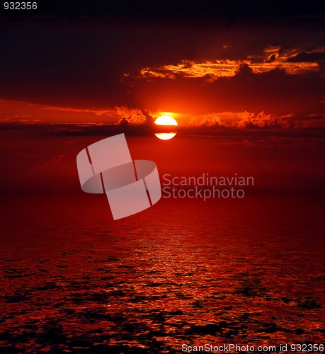 Image of bloody sunrise over sea