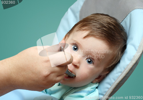 Image of baby feeding by mother
