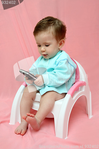 Image of baby with pocket PC on chamber-pot