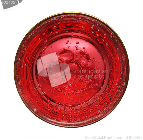 Image of glass with red aerated water