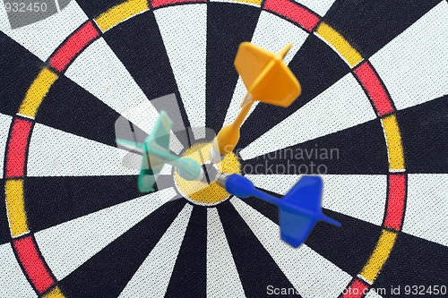 Image of dartboard with darts in aim