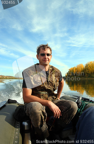 Image of man on inflatable boat with motor