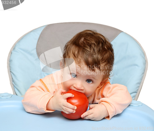 Image of small baby biting tomato