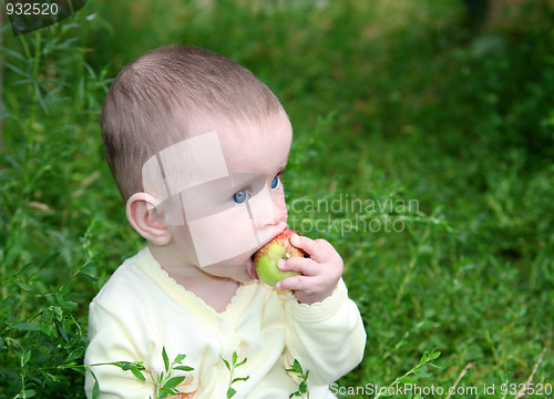 Image of small baby biting apple
