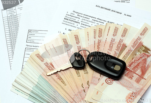 Image of car keys and money on credit contract