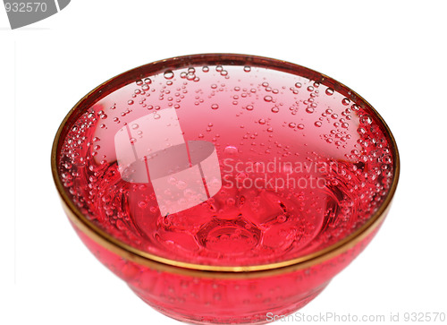 Image of glass with red aerated water