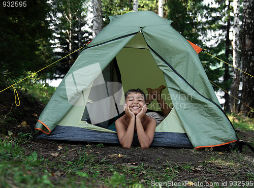 Image of happy boy in camping tent