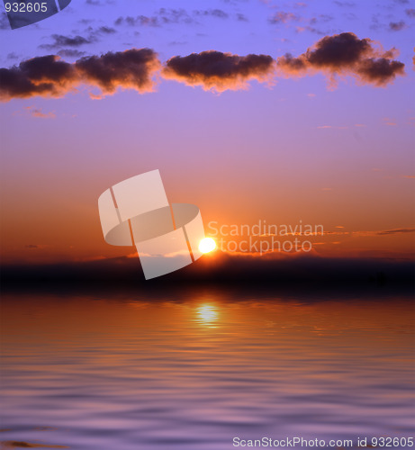 Image of sunrise with clouds over sea