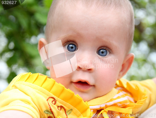 Image of looking baby in yellow 