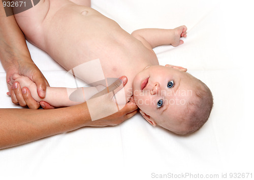 Image of small staring baby massaging