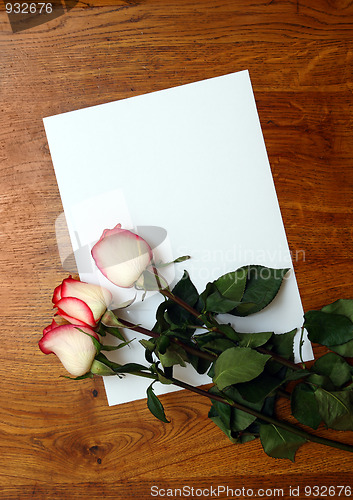 Image of roses and blank paper on table