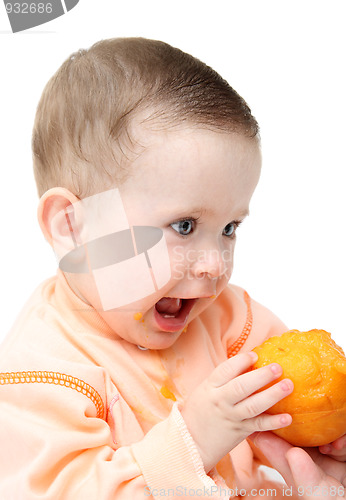 Image of sitting baby eating peach