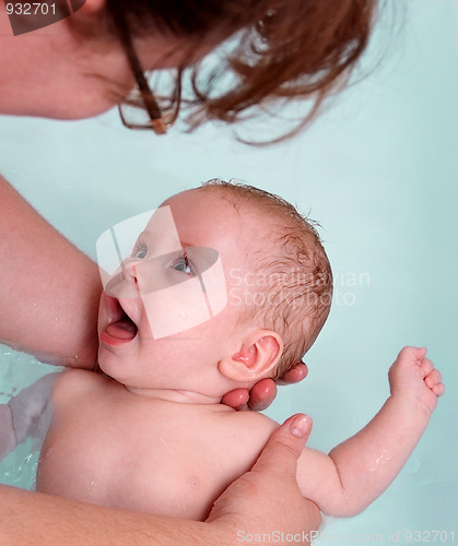 Image of happy baby girl bath by mother