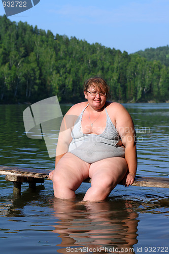 Image of overweight woman sitting on stage