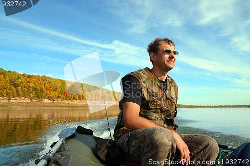 Image of man on inflatable boat with motor