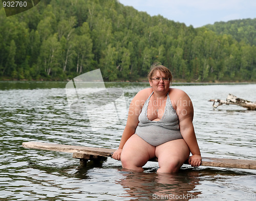 Image of overweight woman sitting on stage