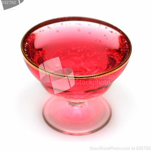 Image of glass with red aerated water