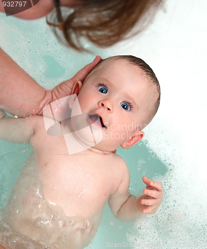 Image of happy baby girl bath by mother