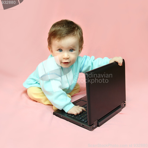 Image of baby sitting with laptop