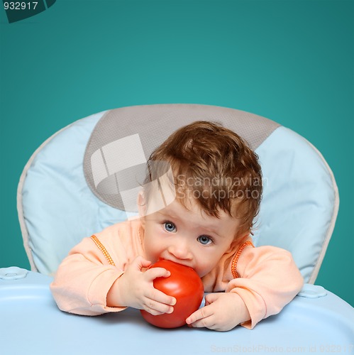 Image of small baby biting tomato