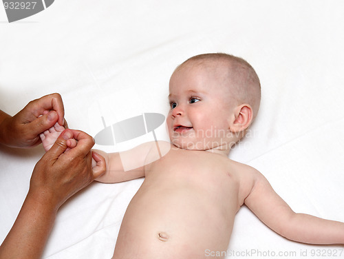 Image of smiling baby massaging