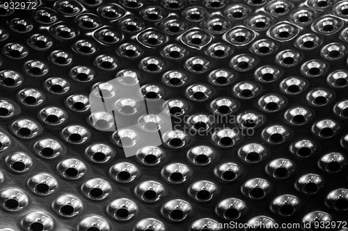 Image of concave metal surface background with holes