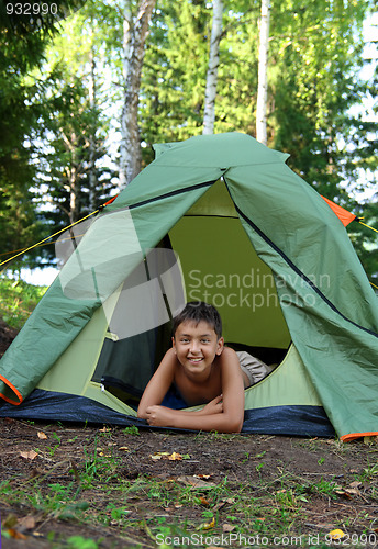 Image of happy boy in camping tent