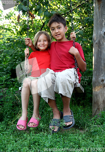 Image of boy and girl on swing