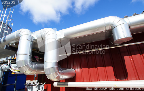 Image of industrial pipelines on pipe-bridge against blue sky 