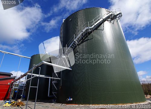 Image of industrial pipelines on pipe-bridge against blue sky 