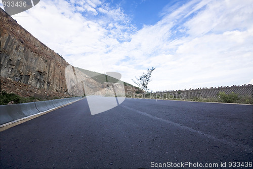 Image of Asphalt road blue sky with clouds and mountains 