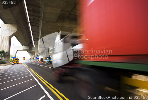 Image of highway under the bridge and container car moving