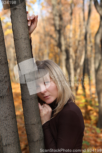 Image of beautiful young girl near tree