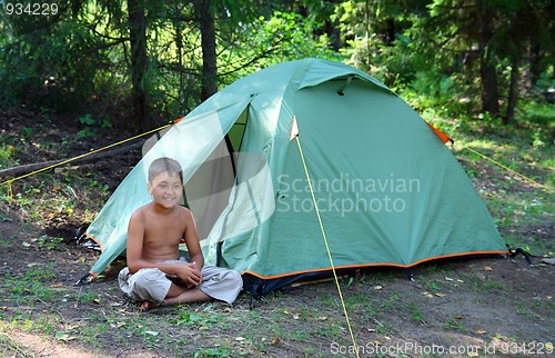 Image of smiling boy near tent
