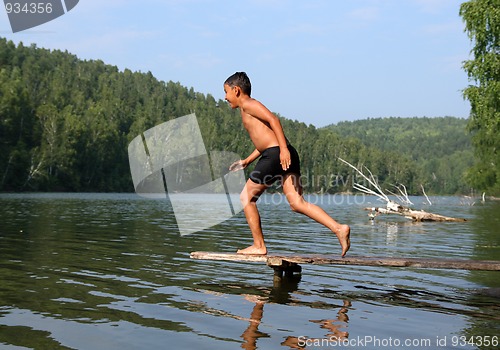 Image of happy asian boy diving in lake
