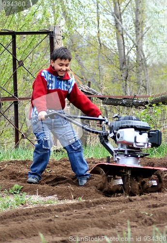 Image of little boy with cultivator