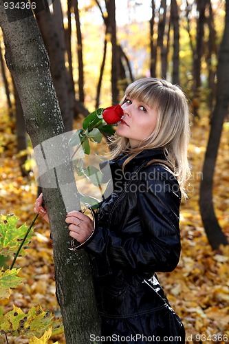 Image of girl with rose in autumn park