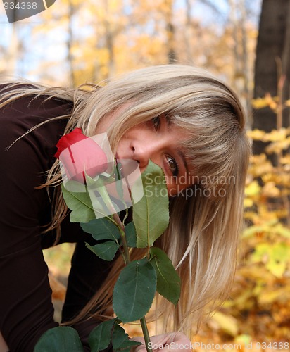 Image of girl with rose in autumn park