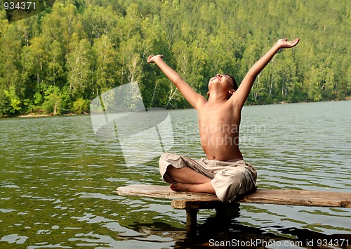 Image of asian boy with hands up on stage