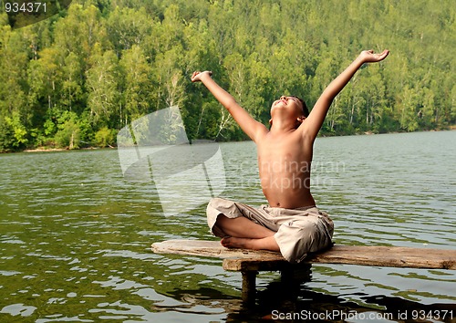 Image of asian boy with hands up on stage