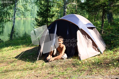 Image of smiling boy near tent