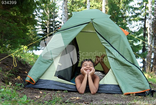 Image of happy boy in camping tent