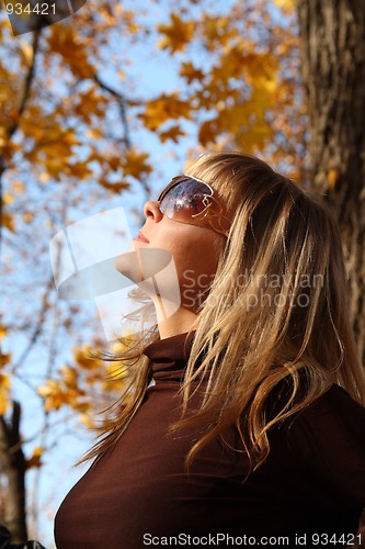 Image of beautiful girl on autumn background