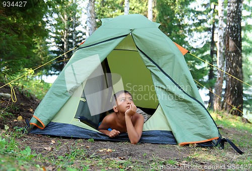 Image of thoughtful boy in tent