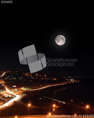 Image of moon over night roads and embankment