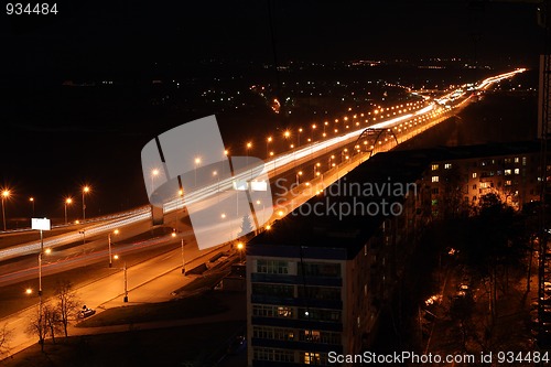 Image of night road through bridge